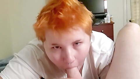 Redheaded teen with tattoos sucking her partner's big dick